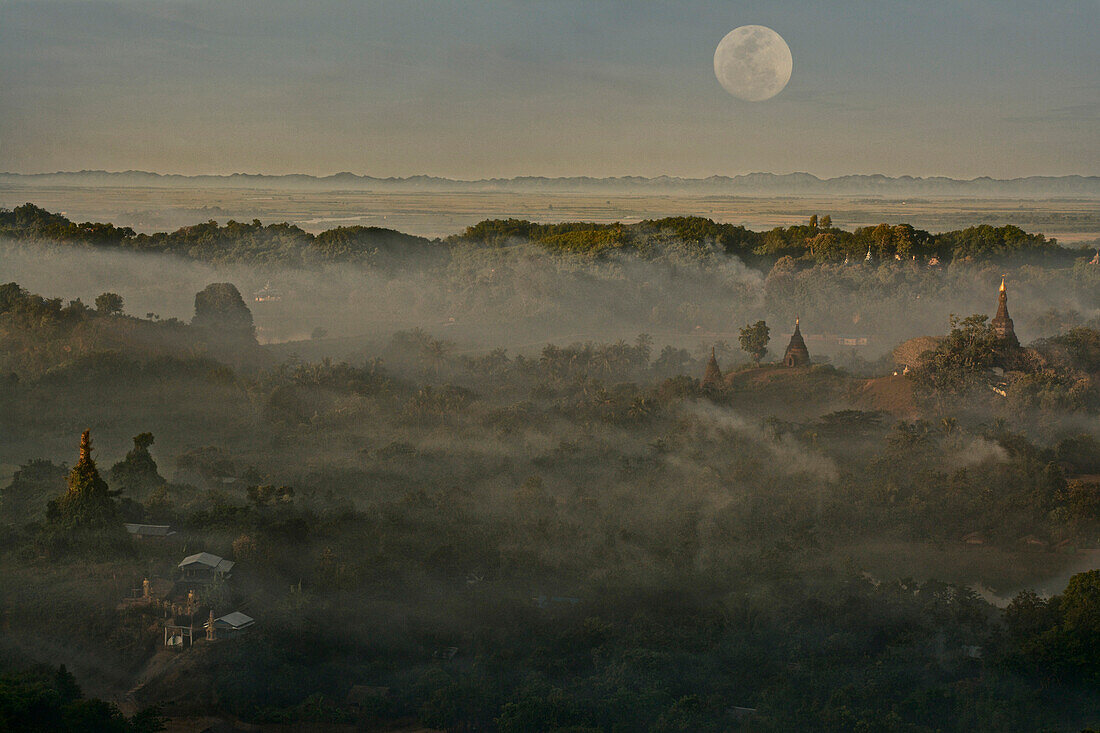 Full moon in Burma, view above hill in the morning mist at Mrauk U, Myohaung north of Sittwe, Akyab, Rakhaing State, Arakan, Myanmar, Burma