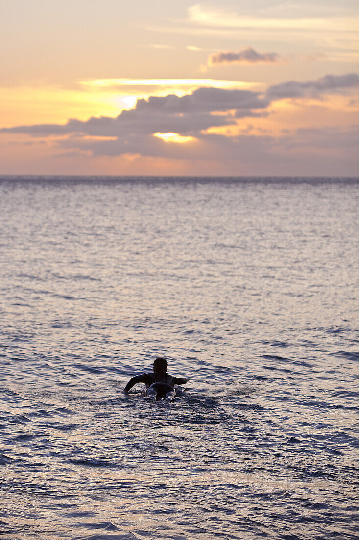 Female surfer paddling, Praia, Santiago, Cape Verde