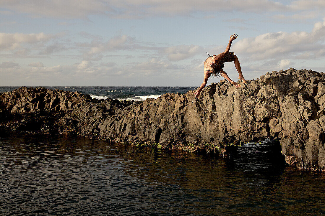 Man jumping into water, Praia, Santiago, Cape Verde