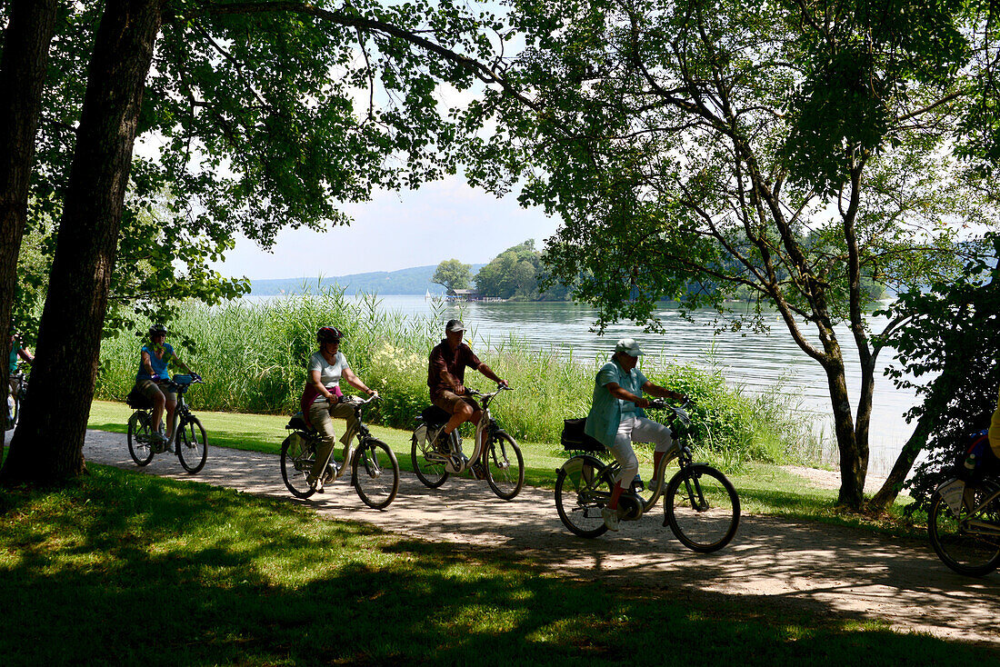 Cycling at Rosen island near Feldafing, west bank of Lake Starnberg, Bavaria, Germany
