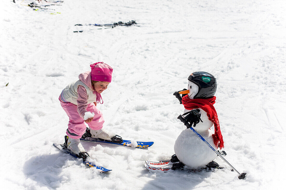 Girl and snowman with skies, Kreischberg, Murau, Styria, Austria