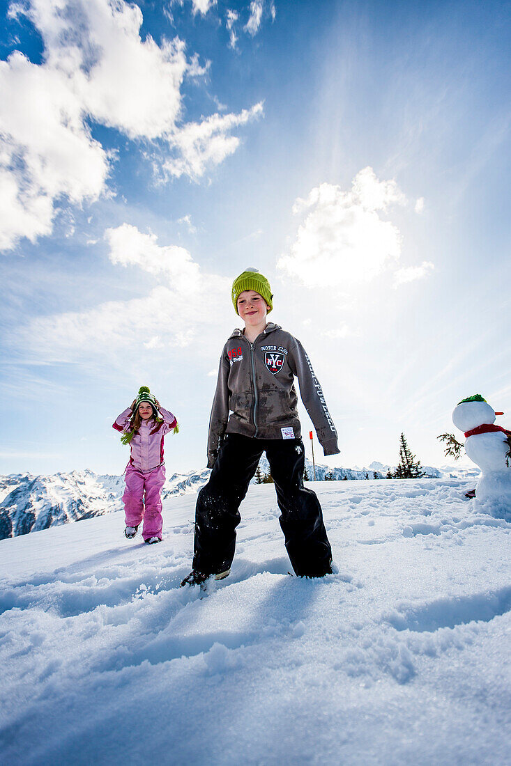 Two children in snow, Planai, Schladming, Styria, Austria