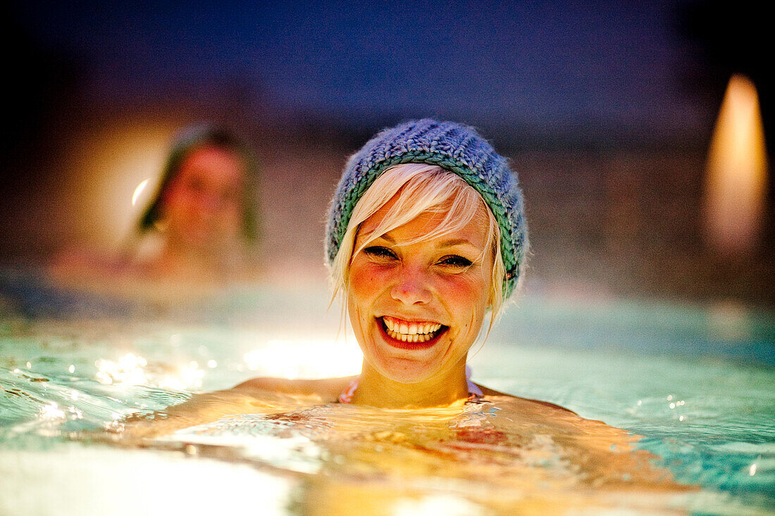 Young woman wearing a knit cap in thermal bath, Bad Radkersburg, Styria, Austria