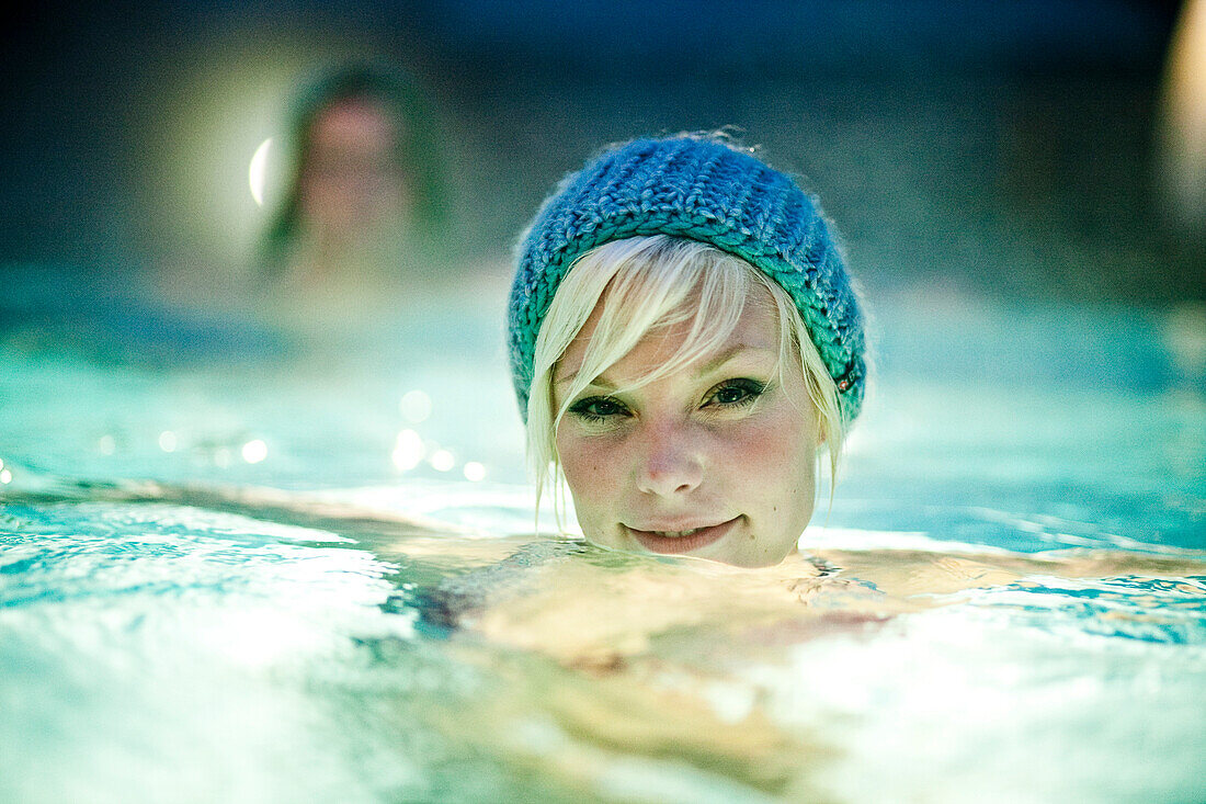 Young woman wearing a knit cap in thermal bath, Bad Radkersburg, Styria, Austria