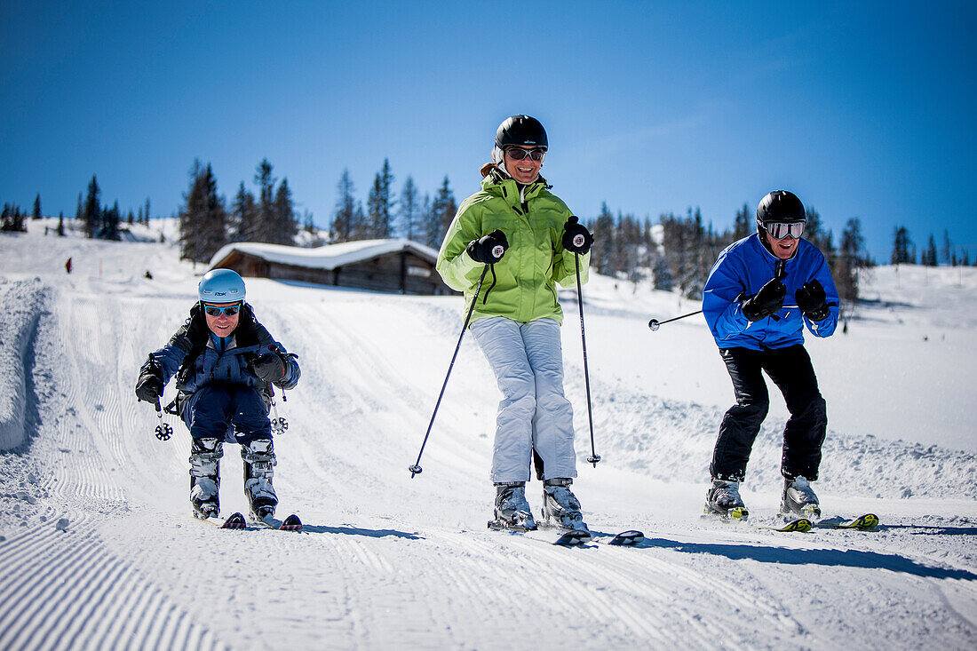 Three skiers on slope, Fageralm, Salzburg, Austria