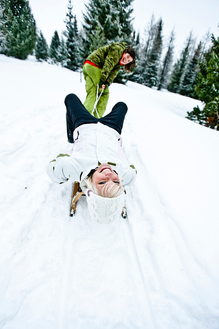 Two young women with a sledge