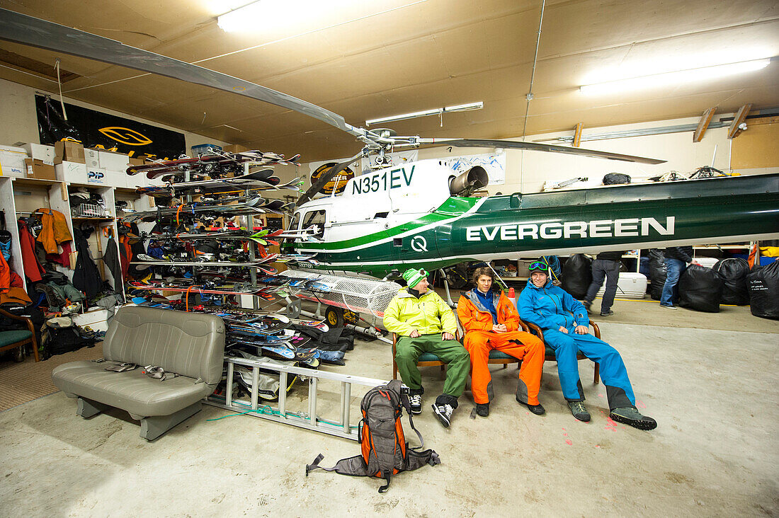 Heliskier sitting inside a hangar, Chugach Powder Guides, Girdwood, Alaska, USA