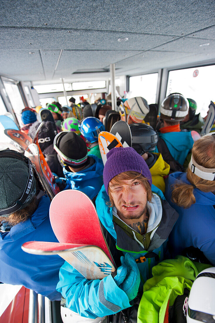 Skiers inside an overhead cable car cabin, Chamonix, Rhone-Alpes, France