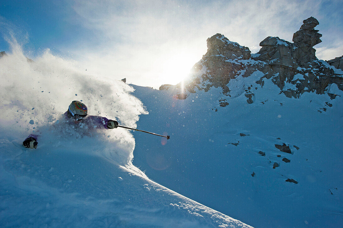 Skier downhill skiing in deep snow, Hintertux Glacier, Zillertal, Tyrol, Austria