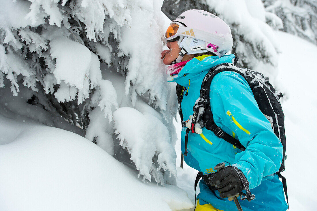 Female skier tasting snow, Alpbachtal, Tyrol, Austria