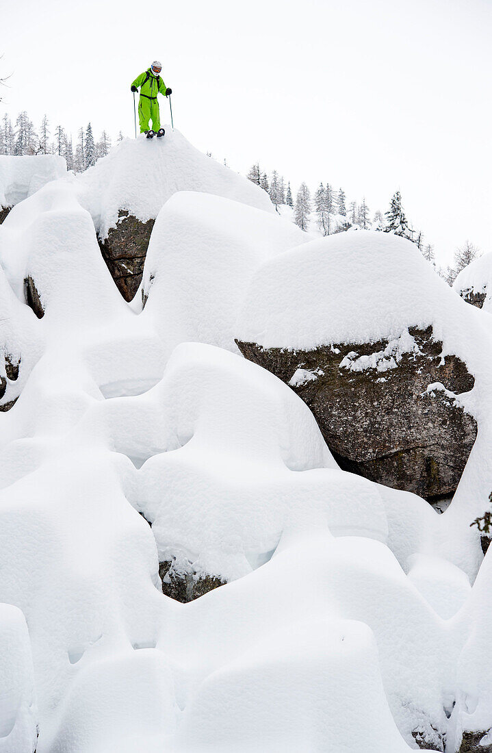 Skier looking over downhill run, Nassfeld, Carinthia, Austria