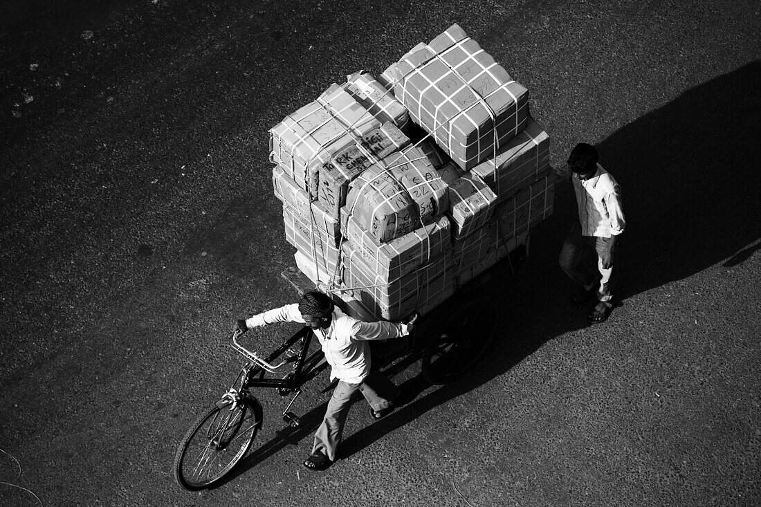 Two guys with a big load on bicycle, Delhi, India