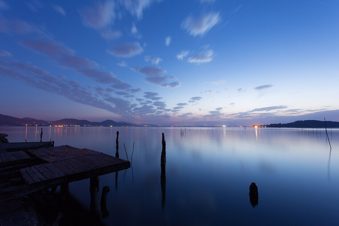 A pier in the lights of a sunset, Trasimeno lake, Umbria