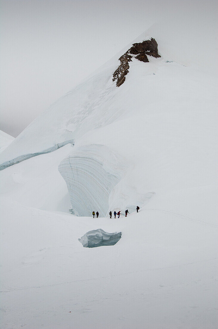 Alpinist under a big crevasse, Parrot Peak, Aosta Valley