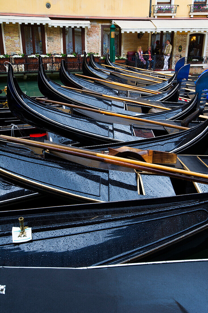 Venetian gondolas parked in a canal in Venice