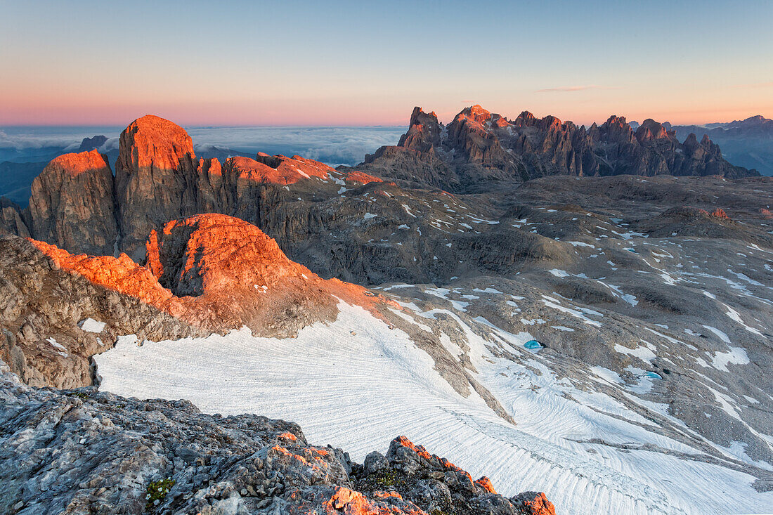 The peaks of the Pale di San Martino Dolomite's group are illuminated by the first summer's sunrise light, Dolomites, Italy