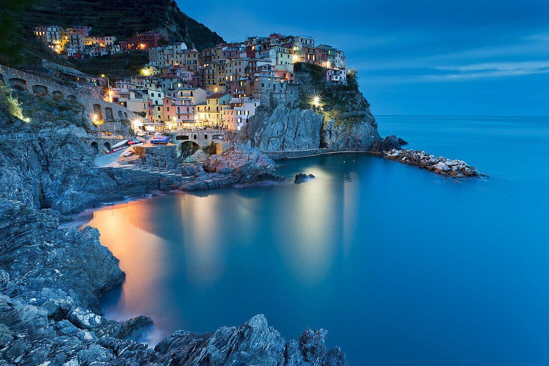 Sunset in Manarola town frontal view, La Spezia, Liguria, Italy