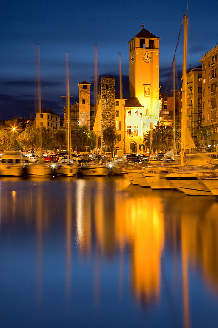La Campanassa with buildings reflected in the sea with boats, Savona, Italy