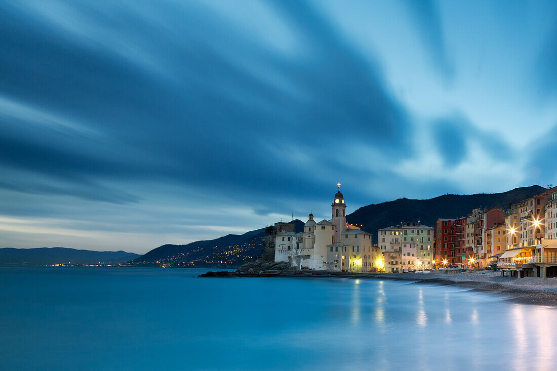 The last lights of the evening over Camogli town, in the cinque Terre site, Liguria, Italy . Panoramic from the beach with sea view .