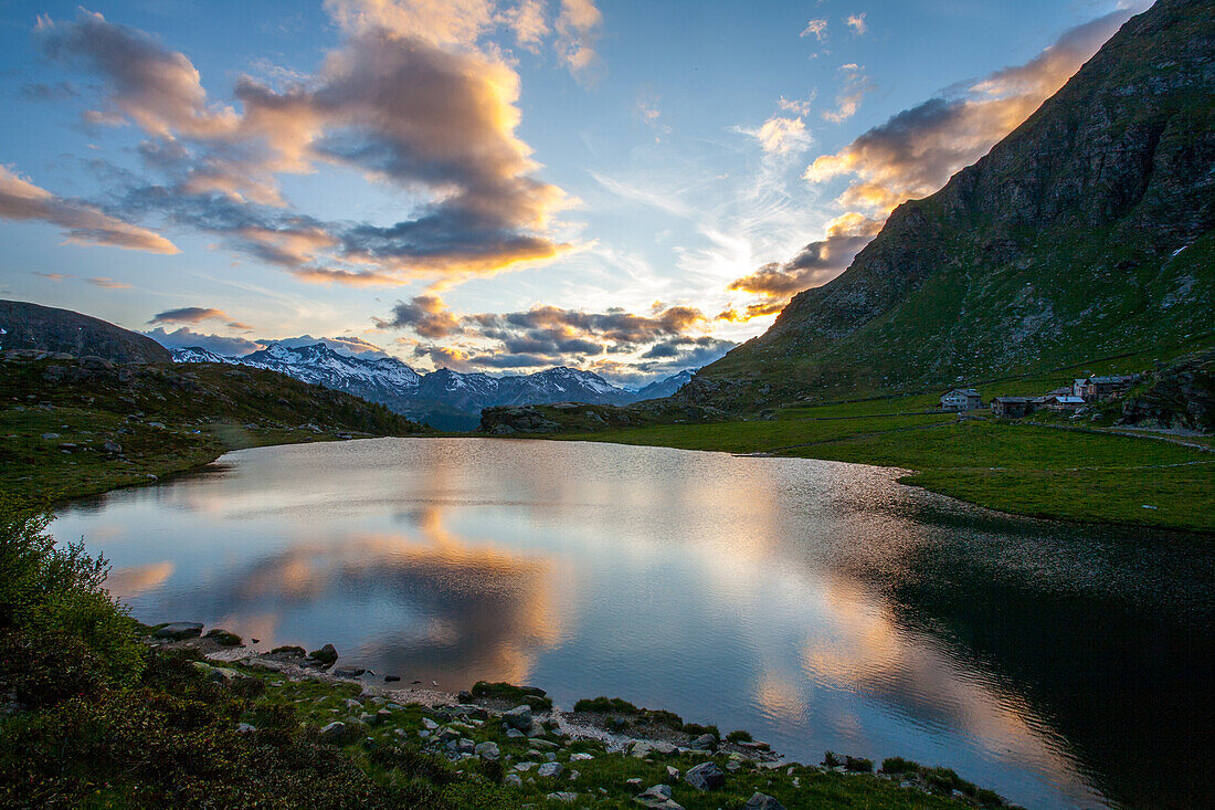 An alpine lake under the colours of a summertime's sunset, Spluga valley, Lombardy