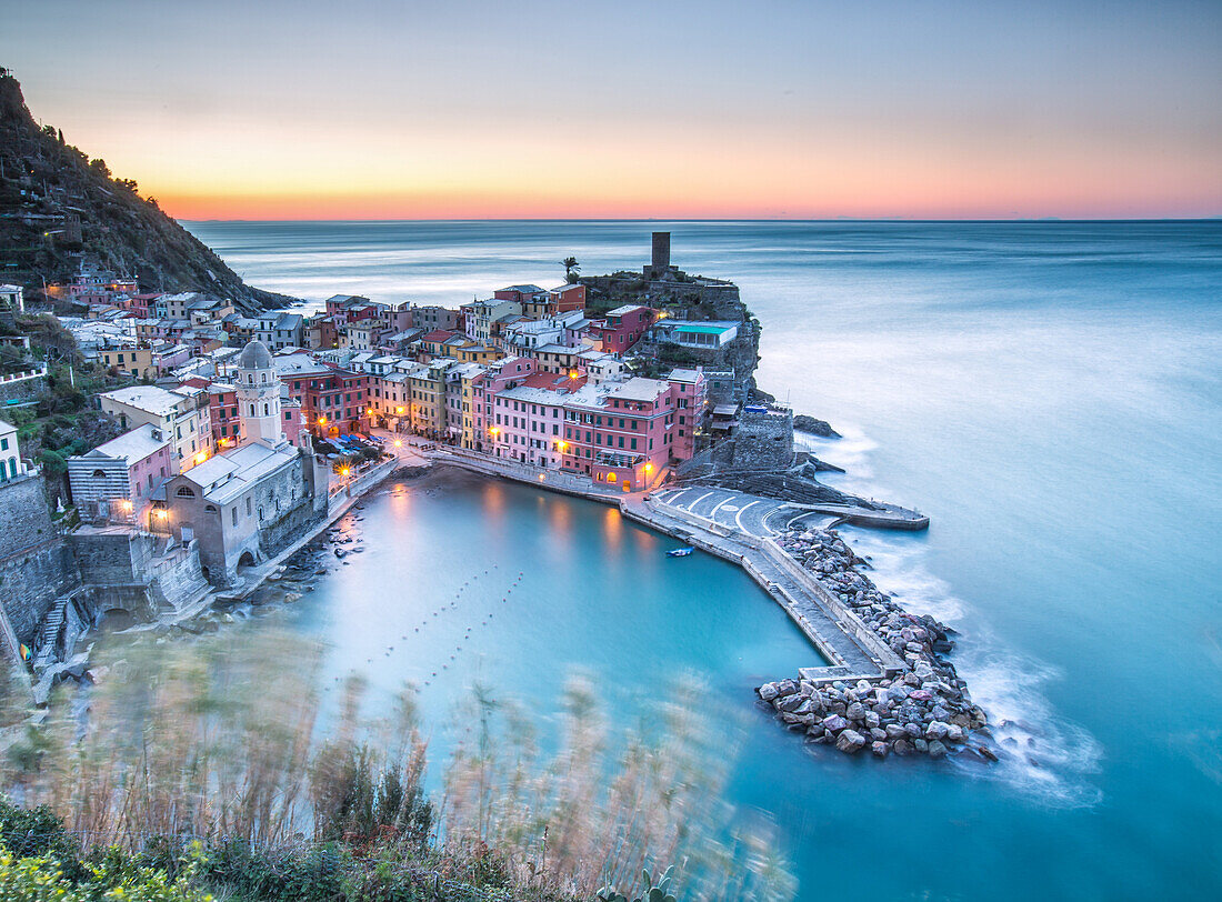 Artificial lights leaving the scene to the delicate colours of the dawn in Vernazza, Cinque Terre National Parc, Liguria, Italy