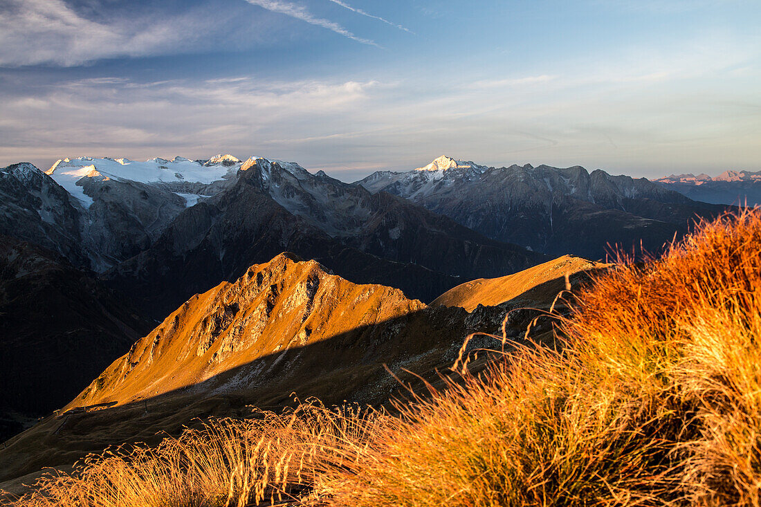 The sun is rising over the Peak of Bleis and the Adamello group in an autumn morning from the Tonale Peak, Lombardy, Italy