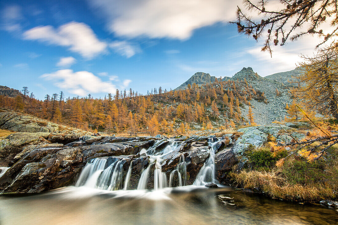 A little waterfall in the autumnal landscape of the Mont Avic natural park. Its water will flow to Lake Bianco, Mont Avic natural park, Aosta valley, Italy