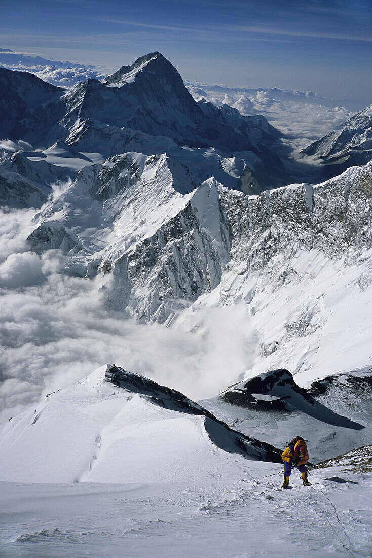 A climber on the summit bid with Makalu in the background.