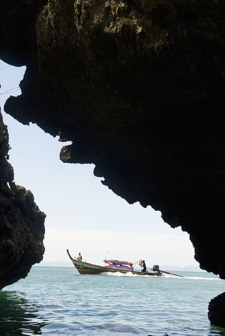View of a speeding longtail boat framed by rock formations on January 7, 2009 in Ao Nang, Thailand.