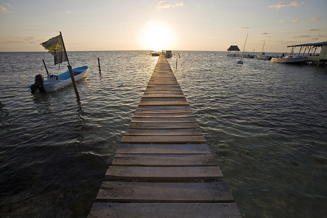 Belize, Central America - Sunrise at one of the many private, wooden piers on the Caye Caulker waterfront.