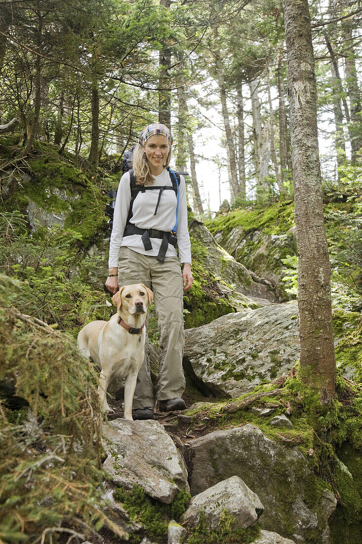 Mid adult woman hiking the Longtrail North to the top of Mt. Abraham in Vermont, USA.