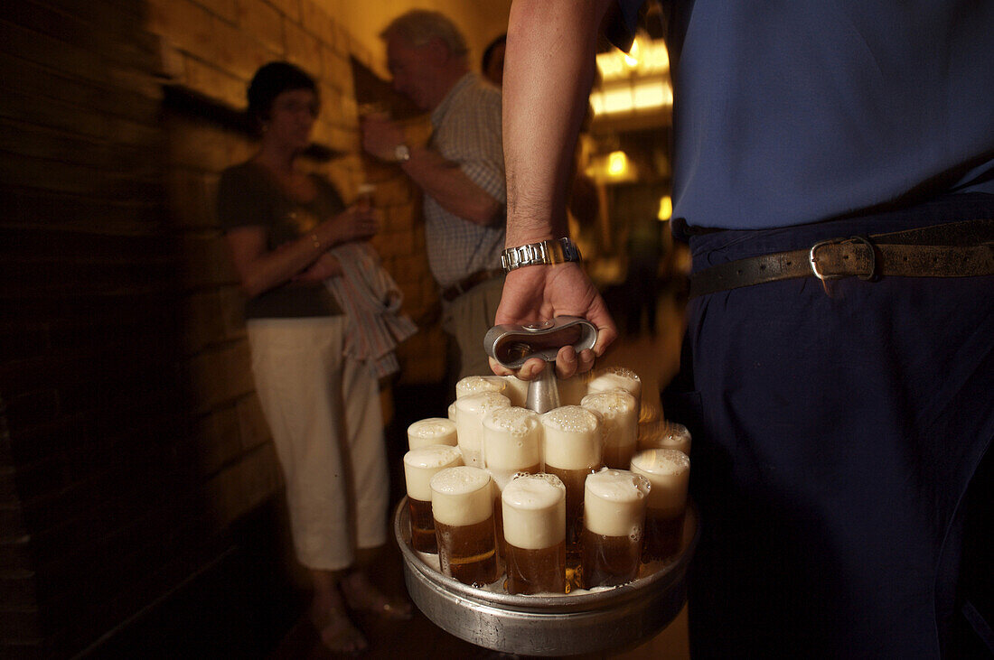 Beer is carried to tables at the popular Cologne pub Paffgen, where they brew and serve their Kolsch beer.