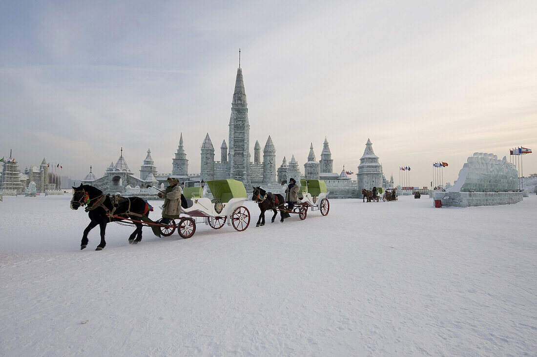 Horse drawn carriages pass an ice replica of the Neuschwanstein castle in Harbin, China on January 17, 2009. The Harbin Ice and snow festivals is one of the world's biggest, and it covers an area of 400,000 square meters, with ice consumption at 120,000 c
