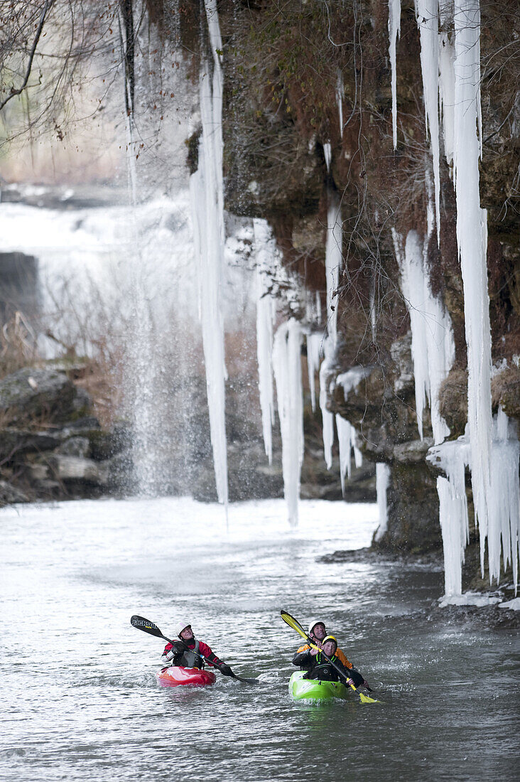 Emily Jackson paddles alongside Dane Jackson and Eric Jackson as they paddle the Dynamic Duo under large icicles on the Caney Fork in Rock Island, TN.