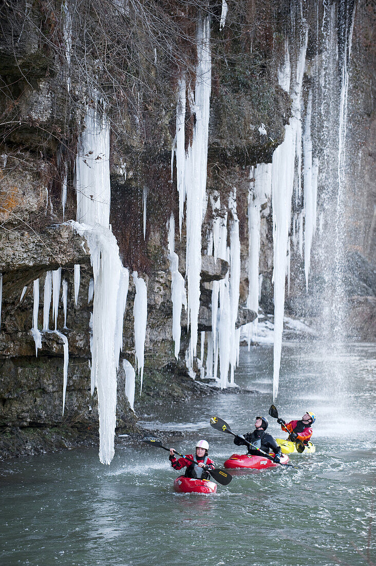 Emily Jackson, Clay Wright and Stephen Wright paddle under overhanging rocks and icicles on the Caney Fork in Rock Island, TN.