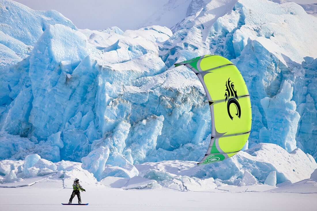Aaron Sales enjoys the views while kiting beneath a massive wall of ice on Inner Lake George, Alaska.