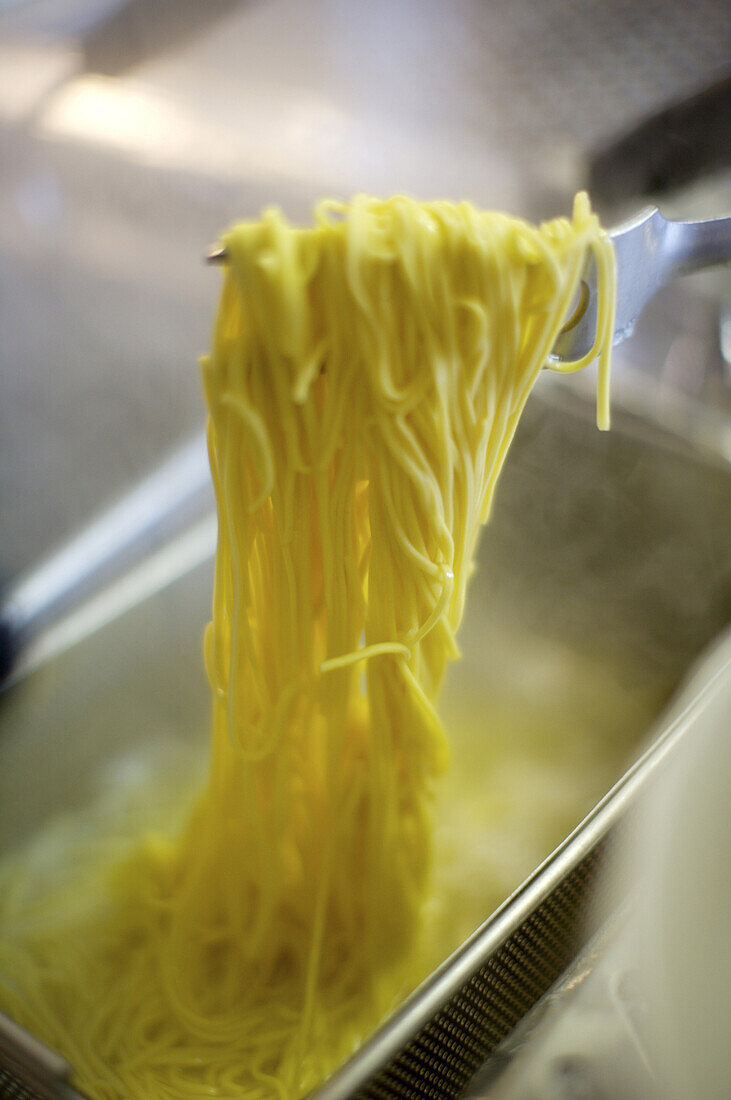 Generic shots of pasta being prepared and consumed in Milan, Italy.