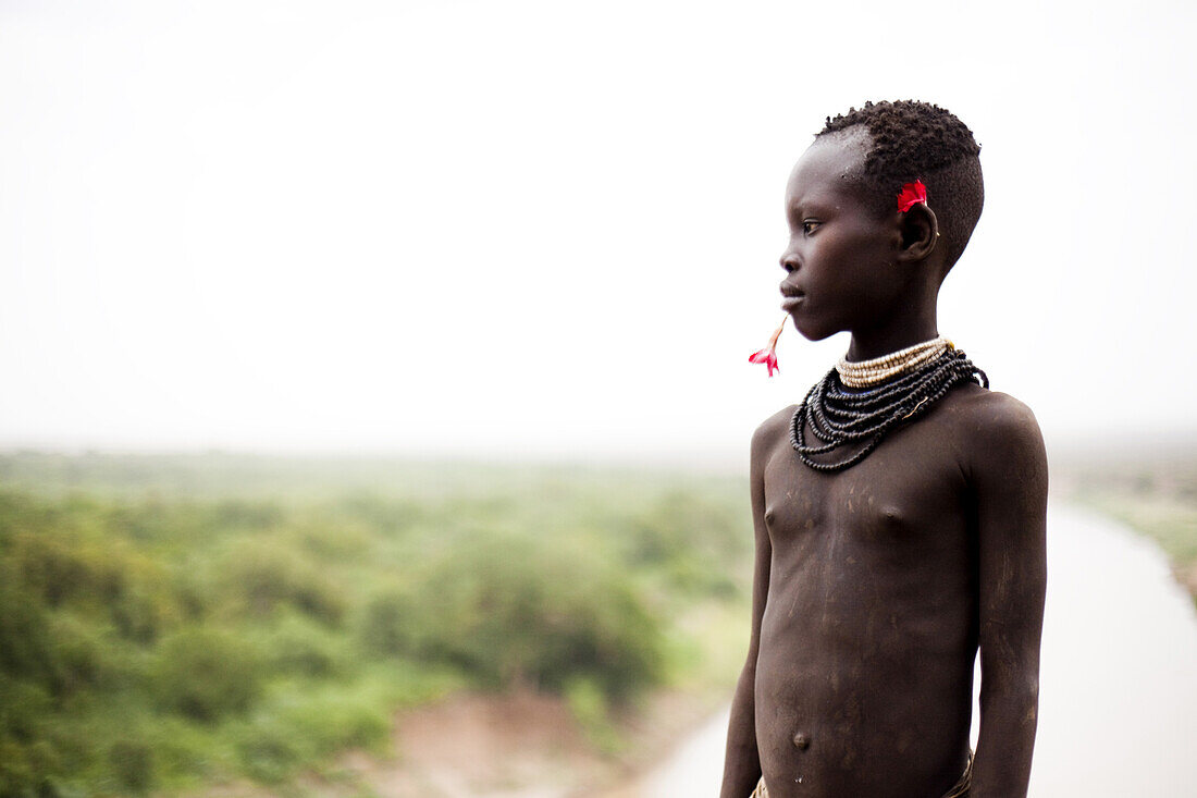 KARO VILLAGE, OMO VALLEY, ETHIOPIA. A portrait of a young boy dressed in the traditional clothes and decoration in the Omo Valley, Ethiopia.
