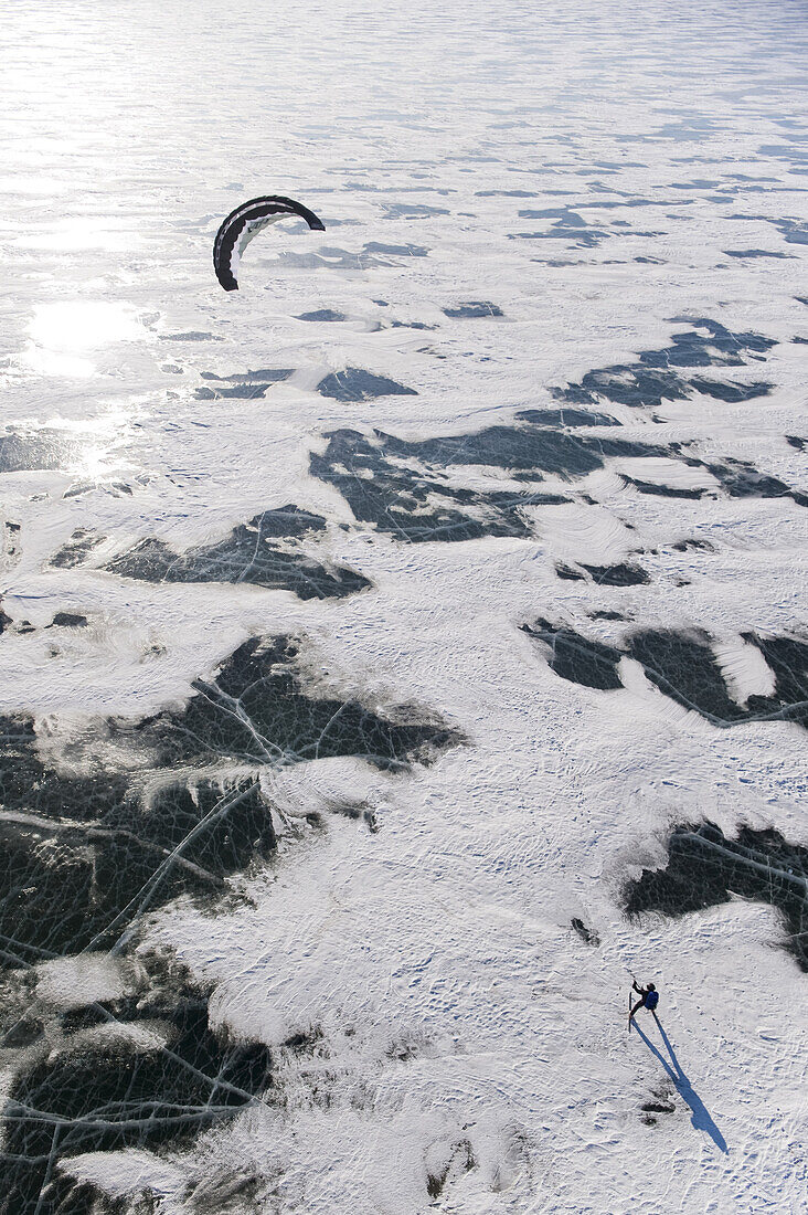 A snowkiter catching the wind on the frozen Missouri River in North Dakota.