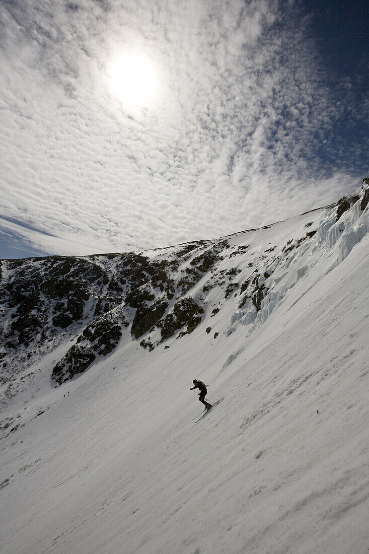 Skiing Tuckerman Ravine on Mt. Washington in the White Mountains of New Hampshire. Mt. Washington, New Hampshire is known for severe weather and home to the Mt. Washington Observatory and also for a spring ritual on Tuckerman Ravine where at time hundreds