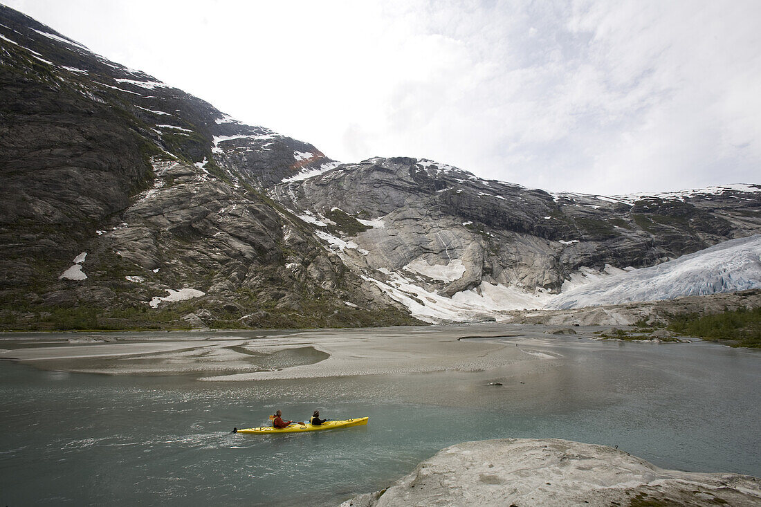 Paul Romer and guide Carlos Caballero kayaking on the Nigardsbreen Glacier,  near Jostedal, Norway. Part of the biggest ice cap in Europe.