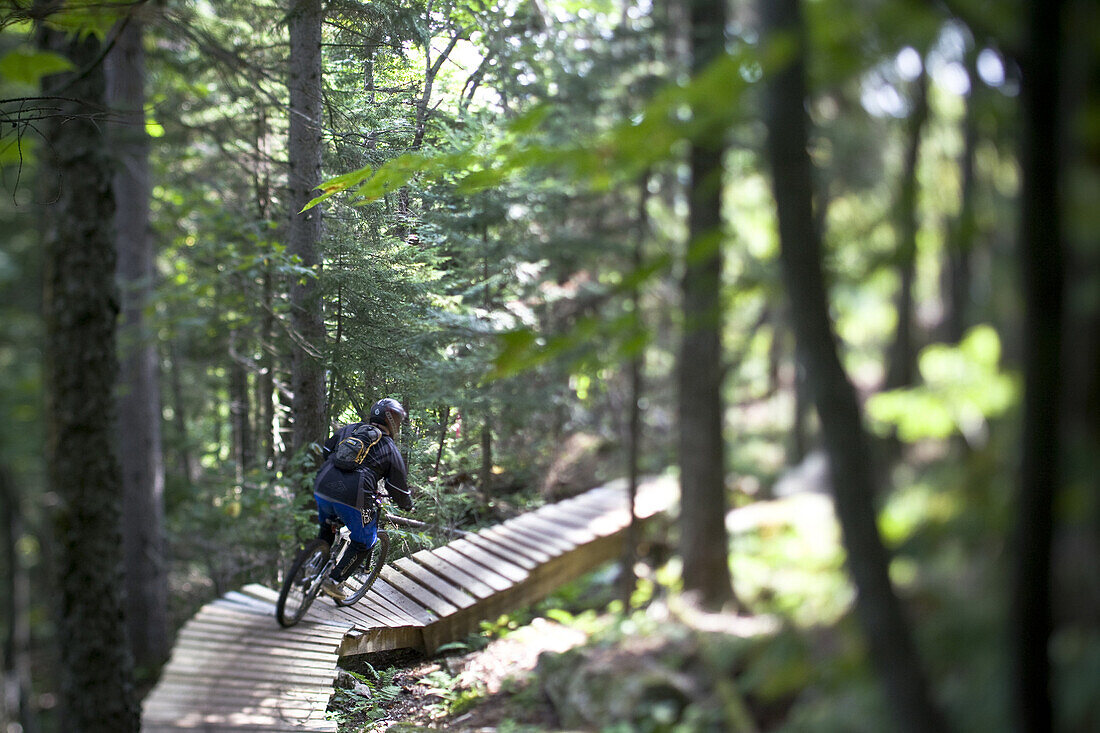 Mountain bikers make their way downhill on lift serviced biking trails at Sunday River Ski Resort in Bethel, Maine.