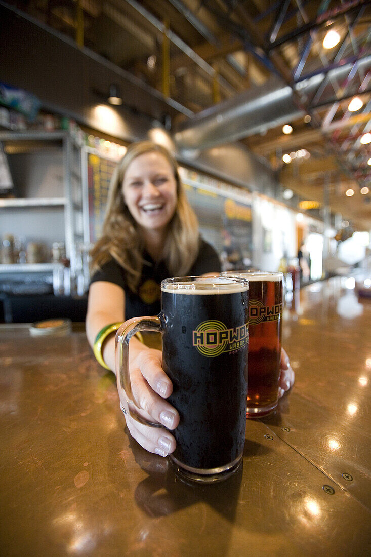 Olivia Magnano serves beer at Hopworks Brewery in Portland, Oregon.  Oregon is known for it's large number of craft brewers.  Hopworks Brewery, owned by Christian Ettinger, brews organic beer and is set up to deliver kegs to retailers on a specially made 
