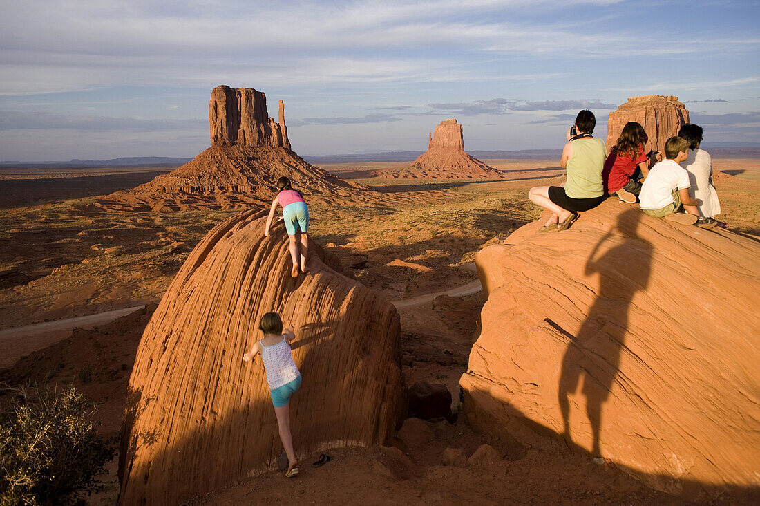 Tourists climb atop rocks photographed by Ansel Adams at Monument Valley Navajo Tribal Park in southern Utah. The park, operated by the tribe, was once a popular set for western films of the 1930s through 60s. It is immensely popular among European touris