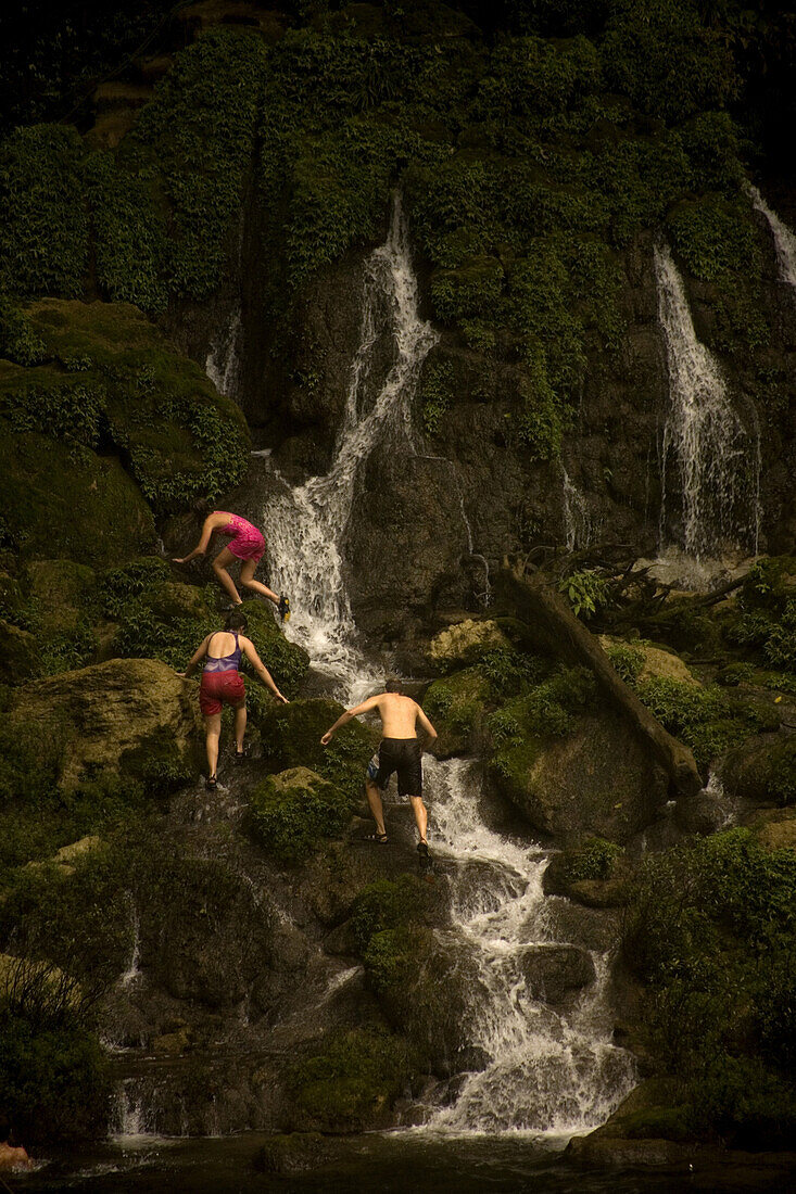 Tourists walk on the rocks at the Misol Ha waterfall in Salto de Agua, Chiapas, Mexico, February 20, 2010.