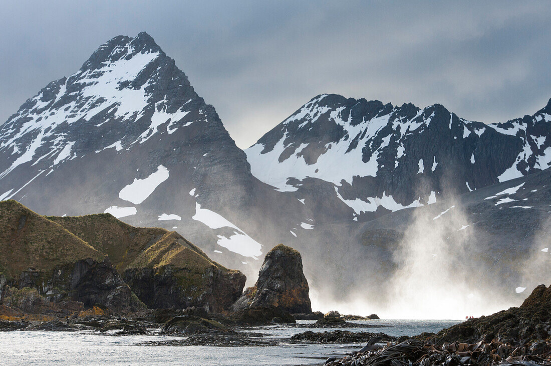 Mist from giant waves and rugged mountains, Prince Olav Harbour, South Georgia Island, Antarctica