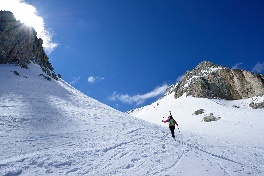 Female back-country skier ascending in Val Culea, Sella, Sella Group, Dolomites, South Tyrol, Italy