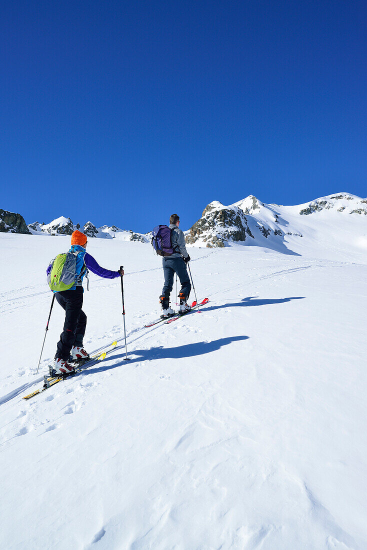 Two back-country skiers ascending to Piz Lagrev, Oberhalbstein Alps, Engadin, Canto of Graubuende, Switzerland