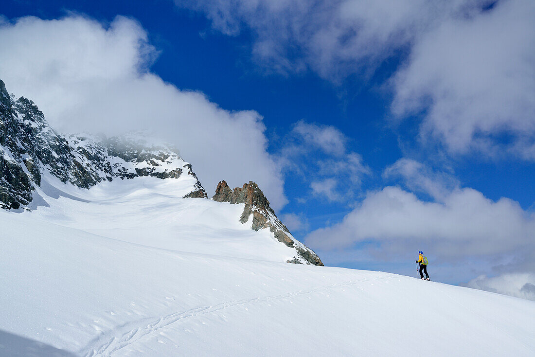 Female back-country skier ascending to Piz Kesch, Engadin, Canton of Graubuenden, Switzerland