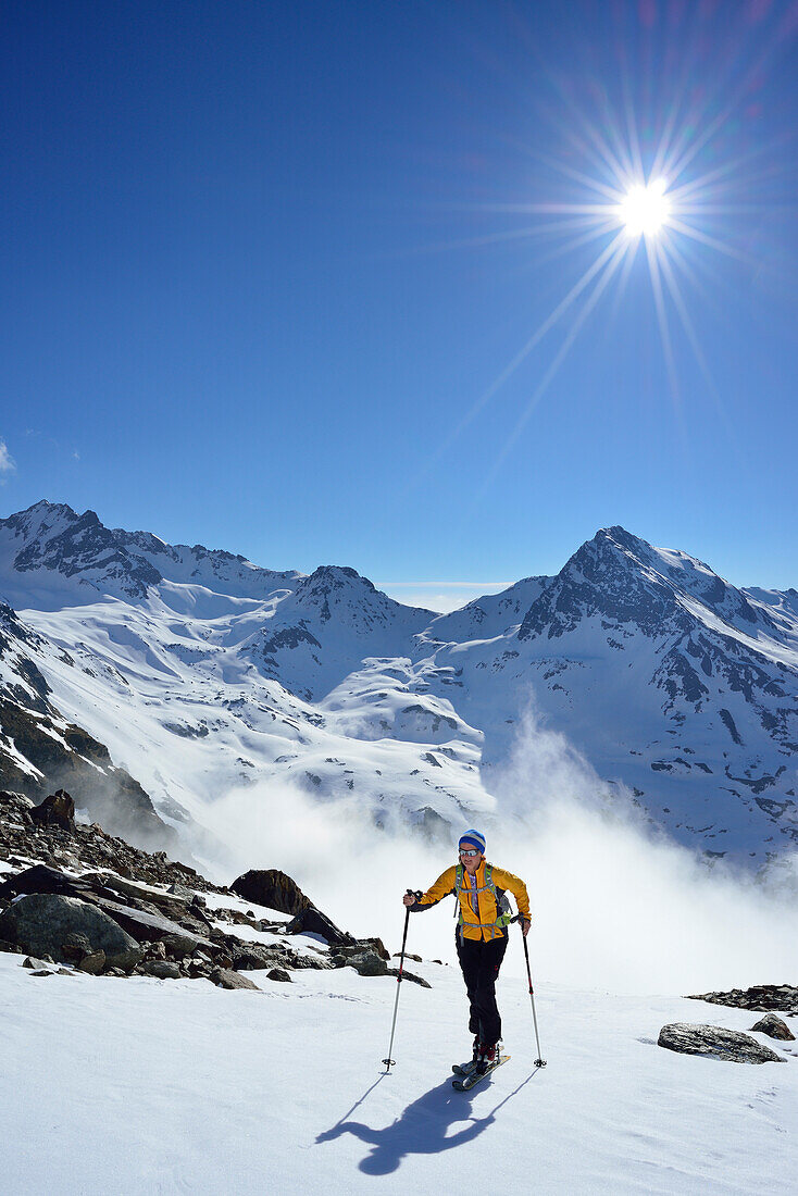 Female back-country skier ascending to Piz Buin, Silvretta Range, Lower Engadin, Engadin, Canton of Graubuenden, Switzerland